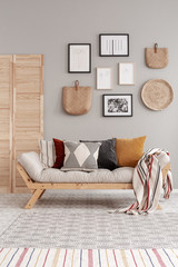 Natural wooden and wicker accessories in contemporary living room interior