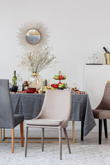 Stylish chair next to elegant dining table set for party