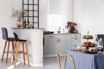 Open plan kitchen and dining room interior idea with white furniture