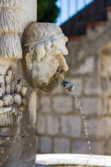 Detail of a fountain at church square of the medieval village of Gourdon near Nice in France.