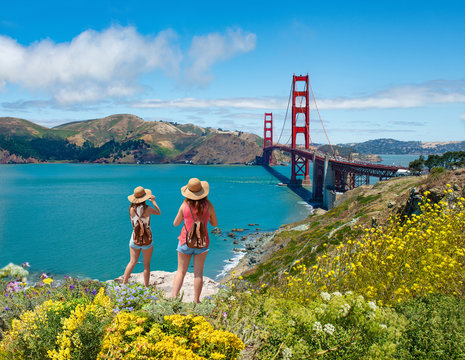 Friends enjoying time together on vacation  trip. Girls looking at beautiful view of Golden Gate Bridge, San Francisco, California, USA