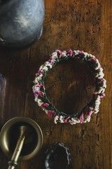 Diadem of dried flowers on an old wooden table to embellish the hair of women in spring.