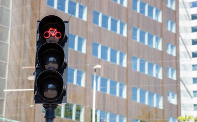 Bicycles red traffic light on building facade background