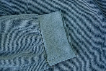 one gray wool sleeve on a piece of old clothes