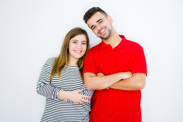 Naklejka premium Young beautiful couple together over white isolated background happy face smiling with crossed arms looking at the camera. Positive person.