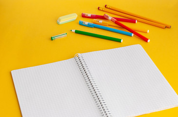Bright modern minimalistic stationery for schoolwork on a yellow background. Back to school concept.