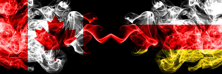 Canada vs South Ossetia smoky mystic flags placed side by side. Thick colored silky smoke flags of Canadian and South Ossetia.