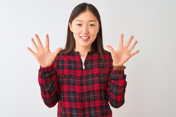 Young chinese woman wearing casual jacket standing over isolated white background showing and pointing up with fingers number ten while smiling confident and happy.