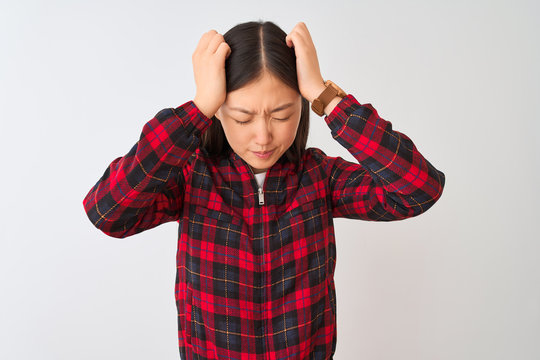 Young chinese woman wearing casual jacket standing over isolated white background suffering from headache desperate and stressed because pain and migraine. Hands on head.
