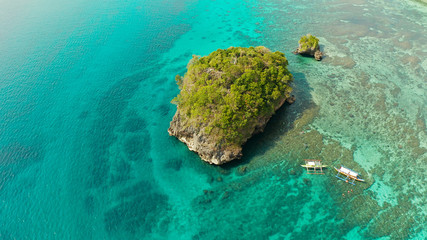 Clear turquoise water in a lagoon with rocky islands and corall reef from above Boracay, Philippines. Summer and travel vacation concept.