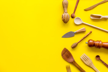 Chef work space with cookware on yellow background top view mock up