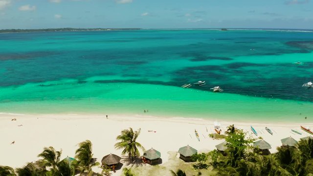 Seascape with beautiful beach and tropical island palm trees by coral reef from above. Daco island, Philippines. Summer and travel vacation concept