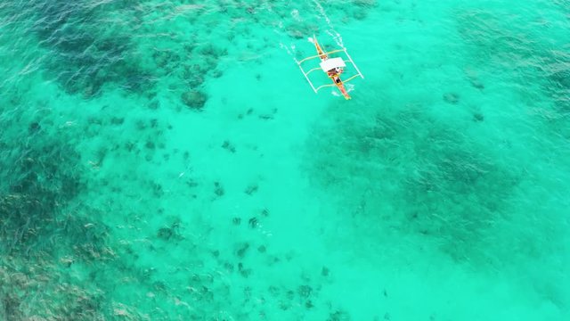 Motor boat on the surface of the lagoon with turquoise water, top view. Summer and travel vacation concept.