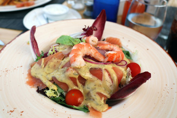 Deliciouse salade with salmon, shrimps, tomatoes, mustard sauce (hovmastar) etc.