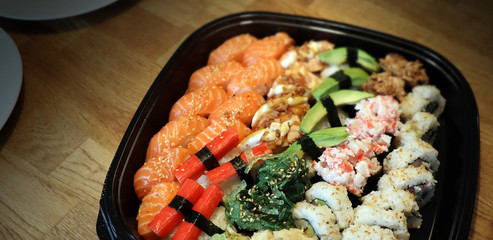 Healthy raw food. Sushi take away for a family. Cold japanese pieces to eat.