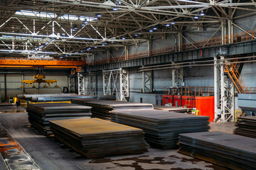 Stacks of steel sheets in warehouse