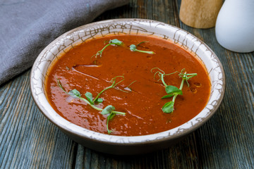 Soup cream of tomato on blue wood table