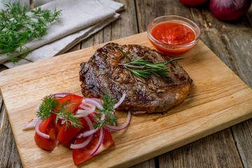juicy Ribeye steak on wooden table