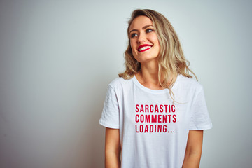 Beautiful woman wearing sacarstic comments loading t-shirt over isolated background looking away to...