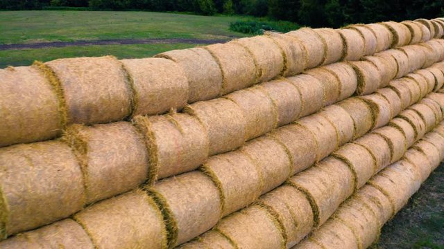 Aerial close-up side view of the roll haystacks