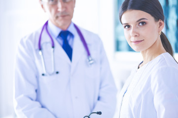 Fototapeta premium Two doctors in conference room in hospital, one of them looking at the camera