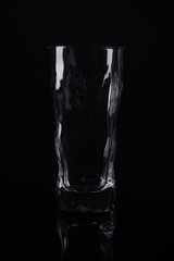 New empty tall glass on black background