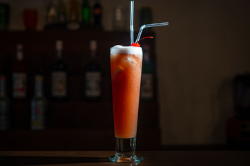 Delicious cocktail on the bar counter close up. With a cherry