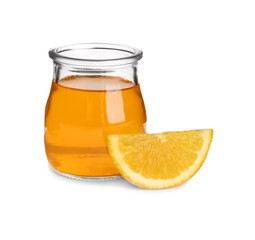 Slice of orange and tasty jelly dessert in glass jar on white background