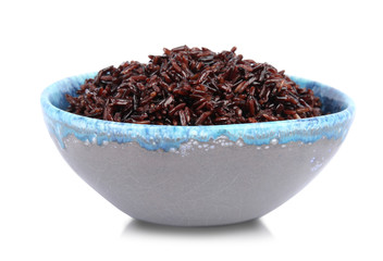 Bowl with delicious cooked brown rice on white background