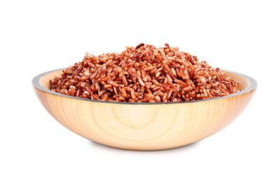 Bowl with delicious cooked brown rice on white background