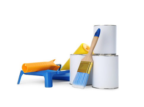 Closed blank cans of paint with brush, roller and tray isolated on white