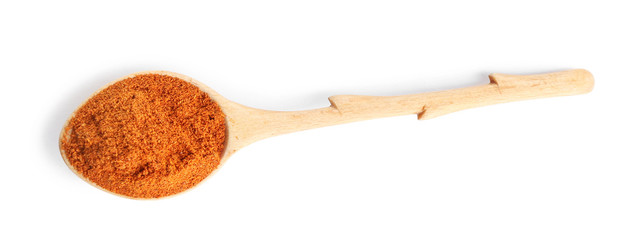 Spoon of ground pepper isolated on white, top view