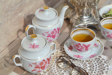 russian samovar with tea cups with herbal tea outdoors