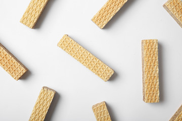 Flat lay composition with delicious crispy wafers on white background