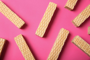 Flat lay composition with delicious crispy wafers on pink background