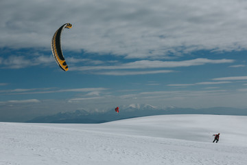 Snow kite surfing in winter mountains.