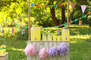 Decorated lemonade stand in park. Summer refreshing natural drink