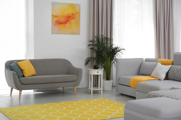 Living room with modern furniture and stylish decor. Color ideas for interior