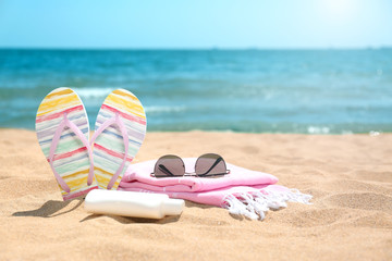 Set of different beach objects on sand near sea. Space for text