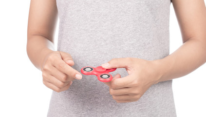 fingers playing a red fidget spinner isolated on a white background