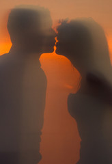 silhouette of bride and groom at sunset