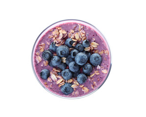 Glass of tasty blueberry smoothie with muesli on white background, top view
