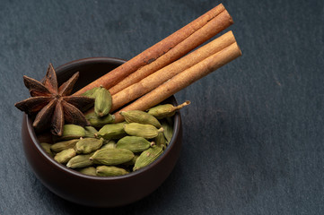 Cinnamon, cardamom and anise in a cup