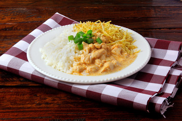 Chicken stroganoff, is a dish originating from Russian cuisine that in Brazil is composed of sour cream with tomato extract, rice and potato chips.