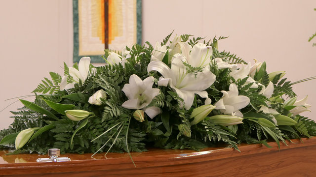 Shot Of Flower And Candle Used For A Funeral