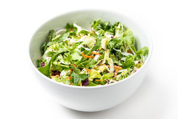 Shredded organic greens in a white bowl