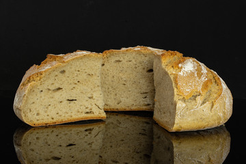 Group of one half two slices of fresh baked rye wheat bread isolated on black glass