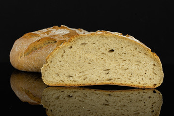 Group of one whole one half of fresh baked rye wheat bread isolated on black glass