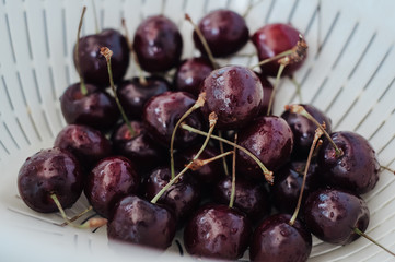 Fresh cherry on clear plate on wooden background. fresh ripe cherries. sweet cherries.