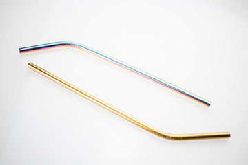 Assorted colorfull reusable drinking stainless steel straws on a white table. zero waste concept